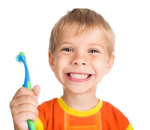 Smiling boy holding a toothbrush